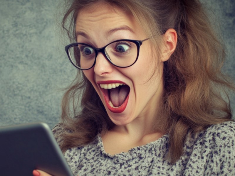 Eine erstaunte Frau mit Tablet.