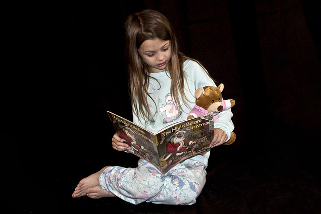 Child Reading with Teddy Bear